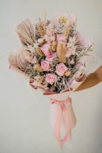 Load image into Gallery viewer, Bouquet of pink roses and dried flowers held by a person against a plain background