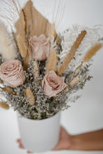 Load image into Gallery viewer, Side angle of the dried floral bouquet in soft natural light, highlighting the textures of roses and bleached botanicals.