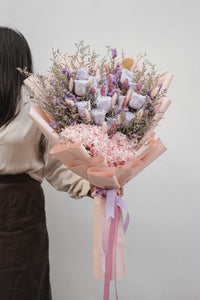 A detailed view of the preserved roses, highlighting the vibrant lilac and soft pink petals, nestled among the delicate texture of the hydrangeas.