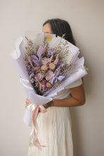 Load image into Gallery viewer, Person holding a bouquet of flowers against a plain background
