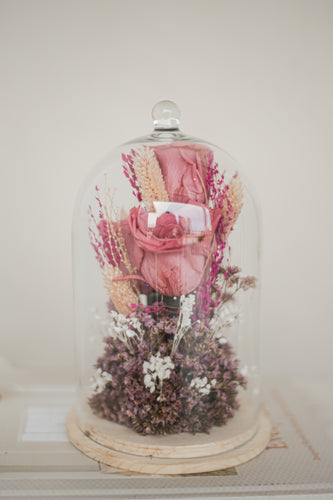 dried and preserved flowers artfully arranged in a glass