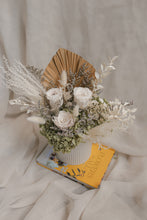 Load image into Gallery viewer, unique vase arranement of dried flowers with a book on a textured surface.
