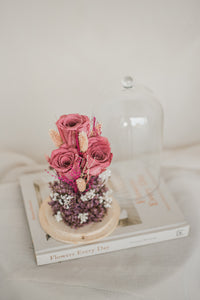 dried and preserved flowers artfully arranged in a glass