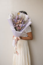 Load image into Gallery viewer, Person holding a bouquet of flowers against a plain background
