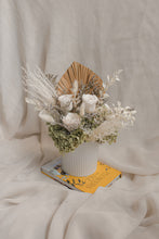 Load image into Gallery viewer, Floral arrangement in a white vase on a book with a soft white background
