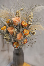 Load image into Gallery viewer, Tall vase filled with dried flowers with orange and peach tones in a gray vase against a neutral background.
