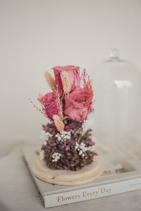 dried and preserved flowers artfully arranged in a glass