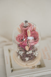 dried and preserved flowers artfully arranged in a glass